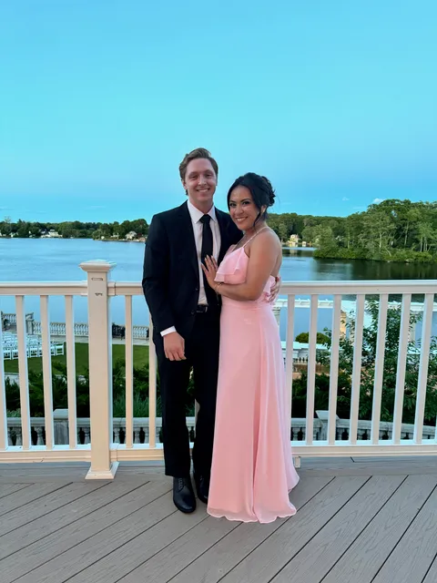 Mark and Vivian dressed up together beside a lake
